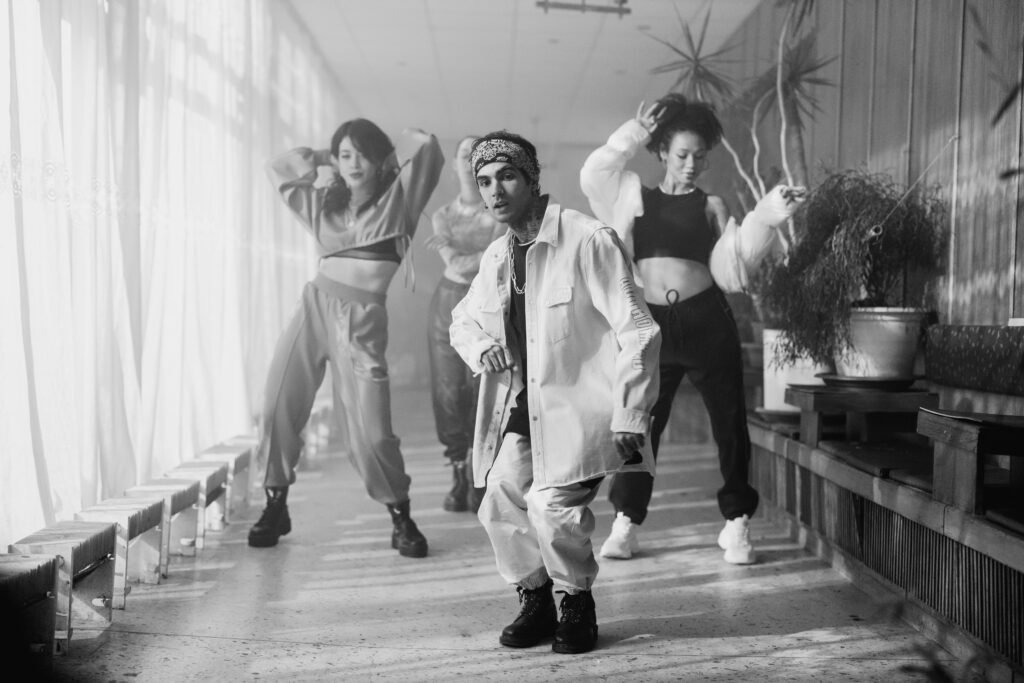 Energetic group of dancers performing Western dance in a stylish indoor setting.